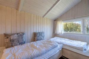 a room with two beds in it with a window at 150-Ringkobing-Krogen-8 in Ringkøbing