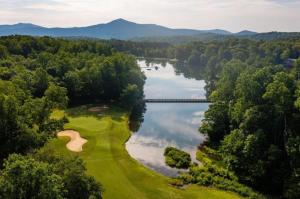 an aerial view of a golf course and a lake at Dobie 48 with Wintergreen Advantage in Wintergreen