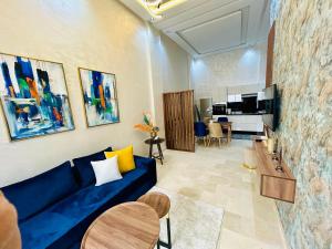 a living room with a blue couch and a table at Casablanca Luxury Studio Apartment Steps to the Beach in Casablanca