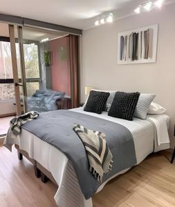 Ένα ή περισσότερα κρεβάτια σε δωμάτιο στο Depto 2D2B, Vista al Volcán, WiFi, Estacionamiento +38 φωτογραφίες