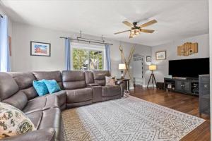 a living room with a couch and a ceiling fan at Blue Door Breeze in Coeur d'Alene