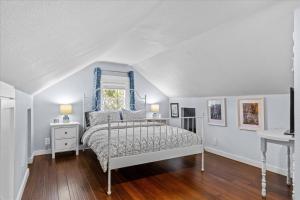 a bedroom with a bed with a blue headboard at Blue Door Breeze in Coeur d'Alene