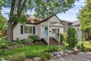 a white house with a blue door and a yard at Blue Door Breeze in Coeur d'Alene