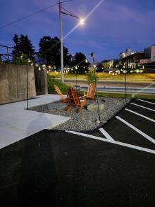 two chairs sitting in a parking lot at night at Stylish Carousel City loft Binghamton NY in Vestal