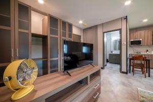 a living room with a fan and a television at Stylish Carousel City loft Binghamton NY in Vestal