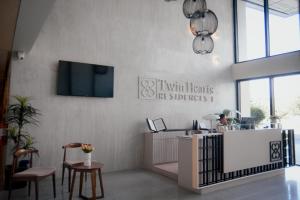 a room with a counter and a tv on a wall at Kabin Tiny Home in Roxas City