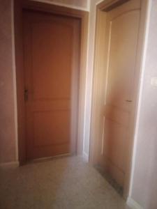 an empty hallway with two doors in a room at APPARTEMENT Family Home 2 Rooms in Sousse