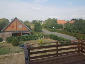 a wooden bench in front of a house at Dorfblick Vacation Rental in Ilsede