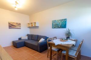 a living room with a couch and a table at Alexandra's apartment in Porto Rafti