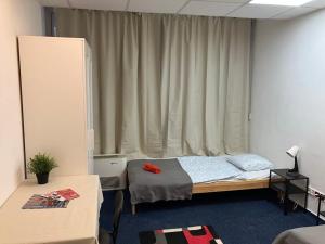 a bedroom with a bed and a window with curtains at Viola Hostel in Budapest