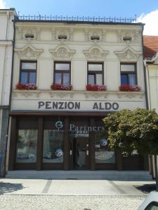 a building with a sign that reads permition aido at Penzion Aldo in Karviná