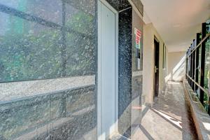 a glass door of a building with a window at Hotel O PMR Hotel in Bengaluru