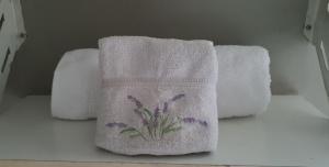 two towels with flowers on them on a shelf at Hotel Cuba in Buenos Aires +46 photos