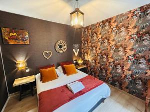 a bedroom with a bed and a wall with a mural at LEtape Prestige Hyper-Centre Calme in Reims