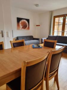 a living room with a wooden table and chairs at Daniela 5 by SMR Rauris Apartments - inc Spa and near Gondola in Rauris
