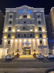 a large white building with cars parked in front of it at Ocean View Al Zahra in Jeddah