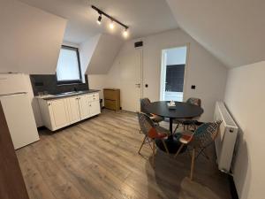 a kitchen and dining room with a table and chairs at La Conac Sibiu in Sibiu