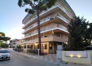 a building with a car parked in front of it at Hotel Marbella in Cervia