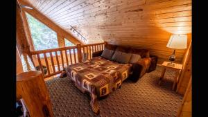 a bedroom with a bed in a log cabin at Island Park Hideaway -Bill's Island -Hot Tub -BBQ in Island Park