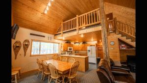 a kitchen and dining room with a table and a staircase at Island Park Hideaway -Bill's Island -Hot Tub -BBQ in Island Park