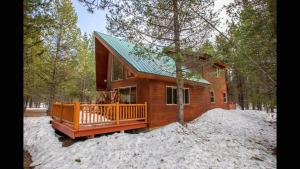 a small cabin in the woods in the snow at Island Park Hideaway -Bill's Island -Hot Tub -BBQ in Island Park