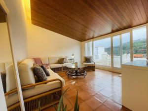 a living room with a couch and a table at Tamariu Platja · Penthouse on Passeig del Mar. in Tamariu