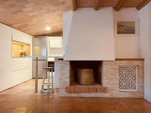 a kitchen with a brick fireplace in a room at Tamariu Platja · Penthouse on Passeig del Mar. in Tamariu