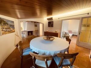 a dining room with a table and chairs at Tamariu Platja · Penthouse on Passeig del Mar. in Tamariu