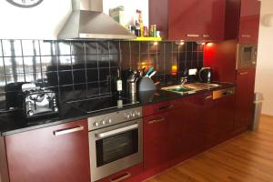 a kitchen with a stove top oven next to a sink at Isabella 5 in Rauris +49 photos