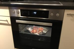 a stove with some food cooking in the oven at Kerstin 3 by SMR Rauris Apartments - inc Spa and near Gondola in Rauris