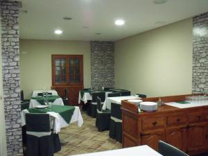 a dining room with tables and chairs in a restaurant at Hostal Salones Victoria in Santa Marina del Rey +2 photos