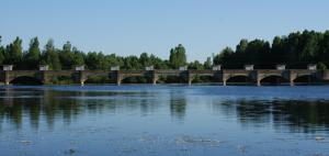 a bridge over a lake with trees in the background at Hostal Salones Victoria in Santa Marina del Rey