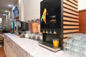 a table with a counter top with a drink on it at Hotel Garda in Affi