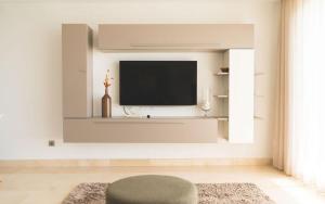 a living room with a flat screen tv on a wall at Exclusivo Atico en La Cala Golf in La Cala de Mijas