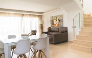 a living room with a table and chairs and a couch at Exclusivo Atico en La Cala Golf in La Cala de Mijas