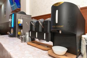 a black coffee maker on a counter in a room at Hotel Garda in Affi