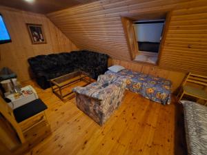 a living room with a couch and a chair at Ranna Resort Hostel in Pärnu