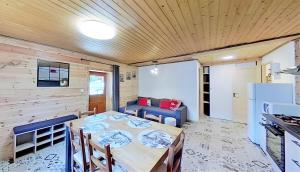 a dining room with a table and a couch at Casa-La Fuste centre Saint-Véran ski au pied in Saint-Véran