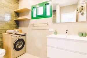 a bathroom with a washing machine and a sink at Casa Roma in Puerto del Carmen