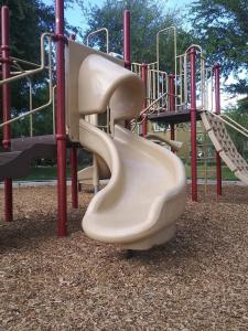 a slide on a playground in a park at VILLA Verde Surprise Stadium - Resort Living in Surprise