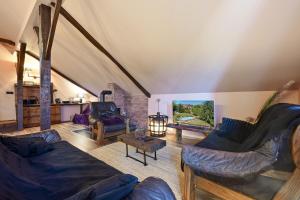 a living room with two couches and a fireplace at Chill House Keti in Kuzminec-Veternički