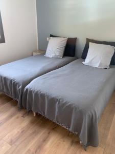 two beds sitting next to each other in a room at La Belle Noiera in Bretenoux +12 photos