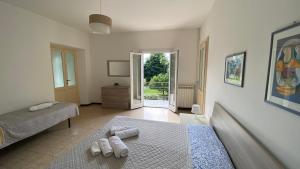 a bedroom with two beds and a door to a yard at Villa Vanda in Castelveccana