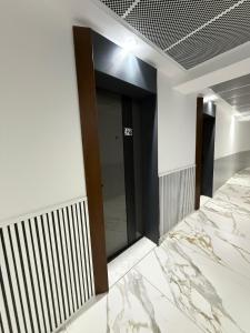 a elevator in a building with a marble floor at Alexander Studio White Titanic in Mamaia Sat/Năvodari
