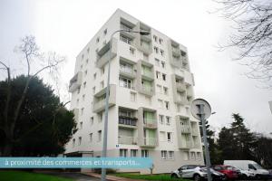 a white building with cars parked in front of it at Grand T2 proche Créteil Soleil et métro ! in Créteil