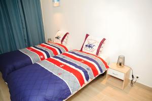 a bedroom with two beds and a night stand at Grand T2 proche Créteil Soleil et métro ! in Créteil