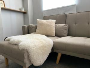 a couch with a white rug on top of it at La Ghiandaia in Mortara