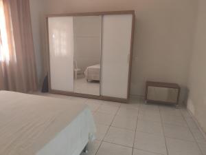 a mirror in a bedroom with a bed and a mirror at Casa aconchegante in São Raimundo Nonato +17 photos