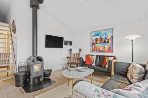a living room with a couch and a wood stove at 342-Hvide-Sande-Anker-Eskildsens-Vej-3-D in Hvide Sande