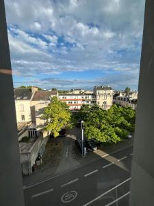 a view of a city street with trees and buildings at We Live In R - Suite 201 in Reims